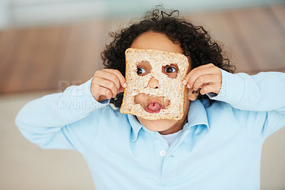 Buy stock photo Child, playful or face food mask or bread funny, nutrition hungry or eating health value. Boy, tongue or brown diet fibre for kid vitality cooking or meal prep dinner humor for snack, lunch or comedy