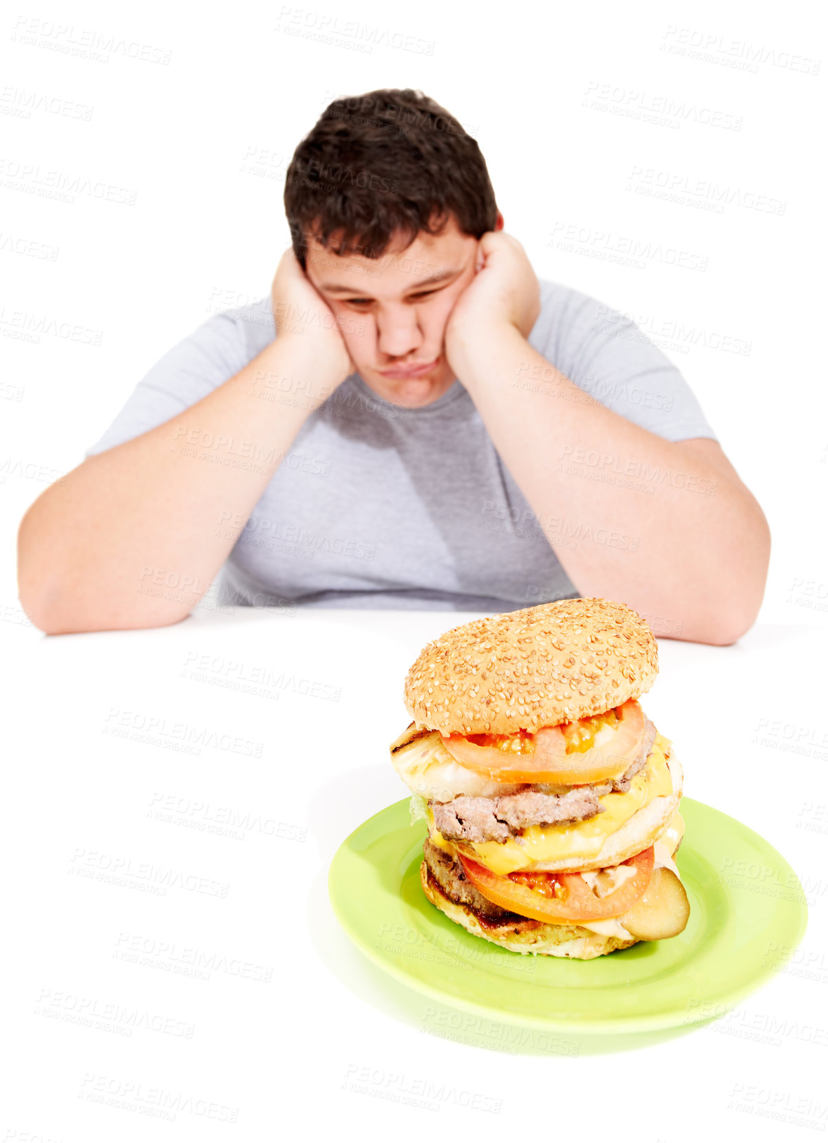 Buy stock photo Sad, plus sized and man with a burger meal in a studio for lunch, supper or dinner for weight gain. Depression, upset and male person with fast food with calories isolated by a white background