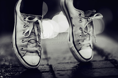 Buy stock photo Balance, shoes or fashion in grayscale on an urban street outdoor for dance or contemporary style. Feet, sneakers or footwear in black and white in a city to explore for travel, tourism or adventure