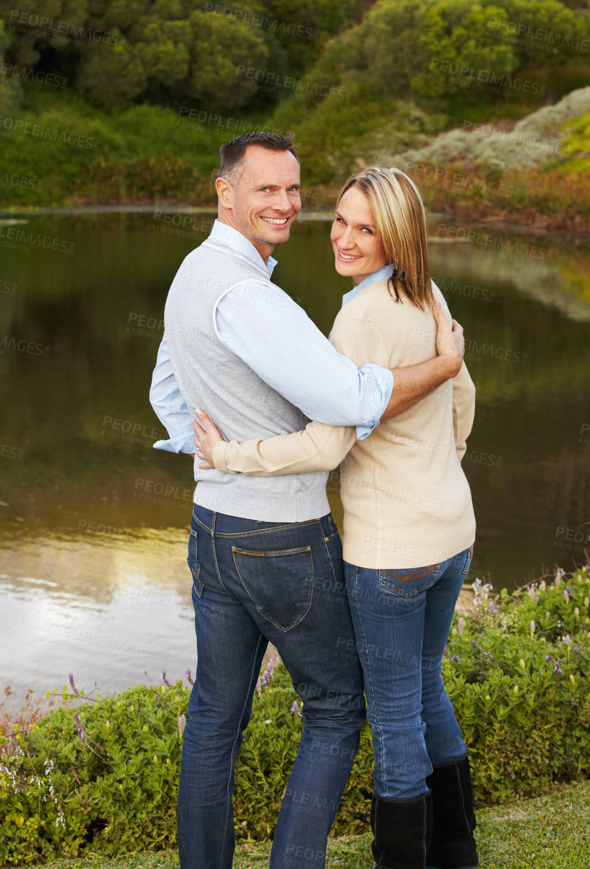 Buy stock photo Portrait of a loving mature couple standing near a lake