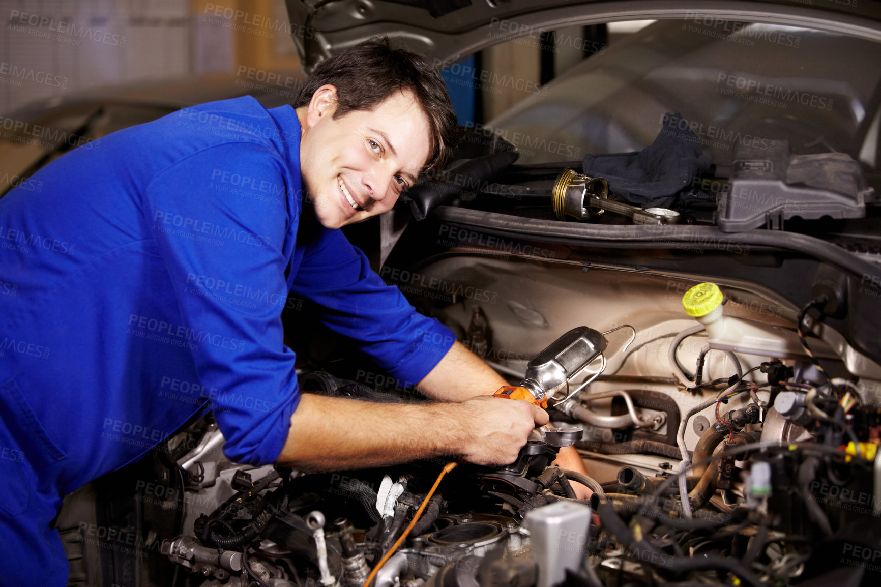Buy stock photo Portrait, smile and car with a mechanic man in a workshop as an engineer looking at the engine of a vehicle. Garage, service or repair with a happy technician working under the hood of an automobile