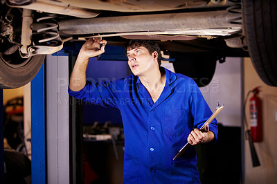 Buy stock photo Car, inspection or maintenance with a mechanic man in a garage for a report on a vehicle repair for insurance. Service, professional and expertise with a young engineer in a workshop for assessment