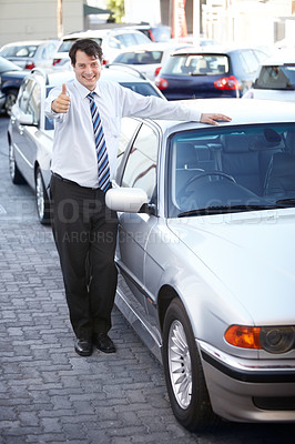 Buy stock photo Portrait, thumbs up and a man at the dealership for a car sale, lease or rental in a commercial parking lot. Smile, retail or agreement with a happy young salesman working in the vehicle trade