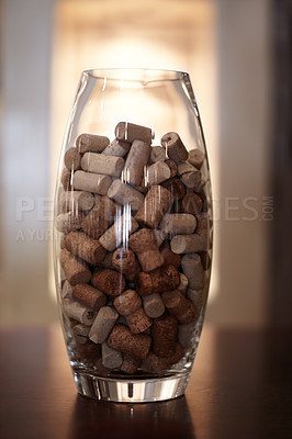 Buy stock photo Winery, glass and jar with a group of cork plugs on a wooden table closeup for decoration or preservation. Background, texture and interior design with stopper seals in a vase for sustainability