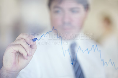 Buy stock photo Shot of a businessman writing on a clear wall with a blue pen