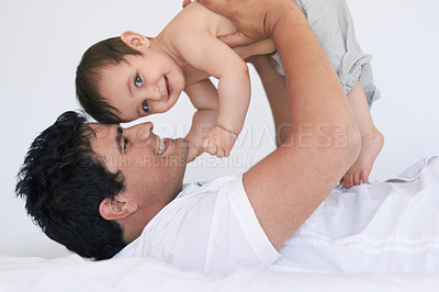 Buy stock photo Shot of an affectionate young father and his baby boy