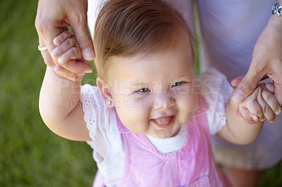 Buy stock photo Baby, steps and happy in garden with help of mom, holding hands and walking outdoor. Child, development and girl laughing and smile on grass, lawn or standing with support of mother to guide movement