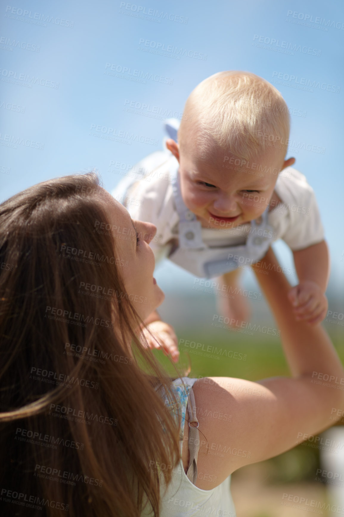 Buy stock photo Woman, lift baby outdoor and happy with care, love and bonding on holiday, summer sunshine and playing together. Mother, infant child and comic laughing in backyard, park or family garden in spring