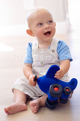 Buy stock photo Happy little baby boy, toy and playing on floor in living room for fun childhood or development at home. Face of cute or adorable newborn child, kid or toddler enjoying play time with airplane toys