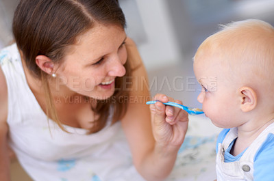 Buy stock photo Mother, baby and feeding food, breakfast and eating for healthy nutrition in home. Happy mom, newborn and feed hungry child, infant or toddler meal with a spoon for growth, development and wellness.