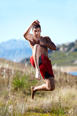 Buy stock photo Portrait, kickboxing and man with training, field and workout with exercise, wellness and nature. Person, athlete or guy with practice, countryside or grass with health, karate or jump with challenge