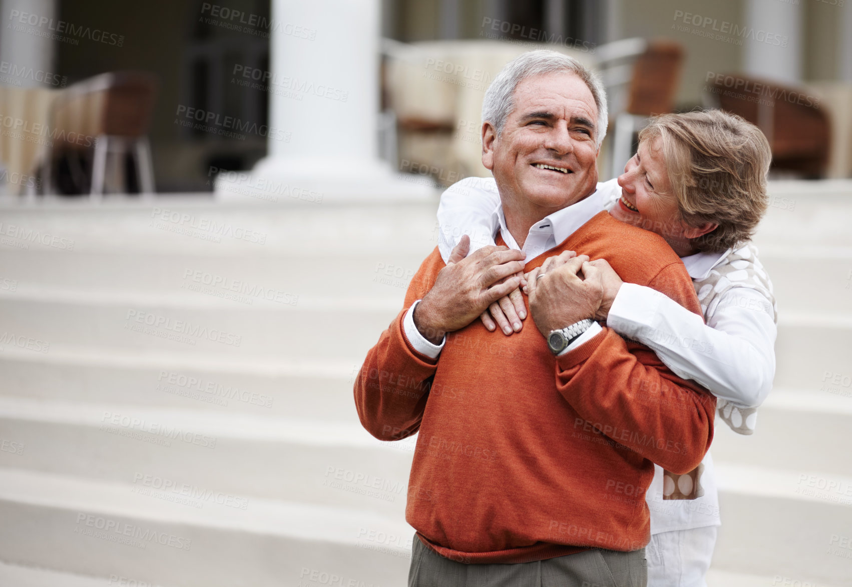 Buy stock photo Hug, retirement and an old couple on hotel steps for travel, vacation or tourism in luxury accommodation. Love, relax or hospitality with a senior man and woman hugging on the staircase of a resort