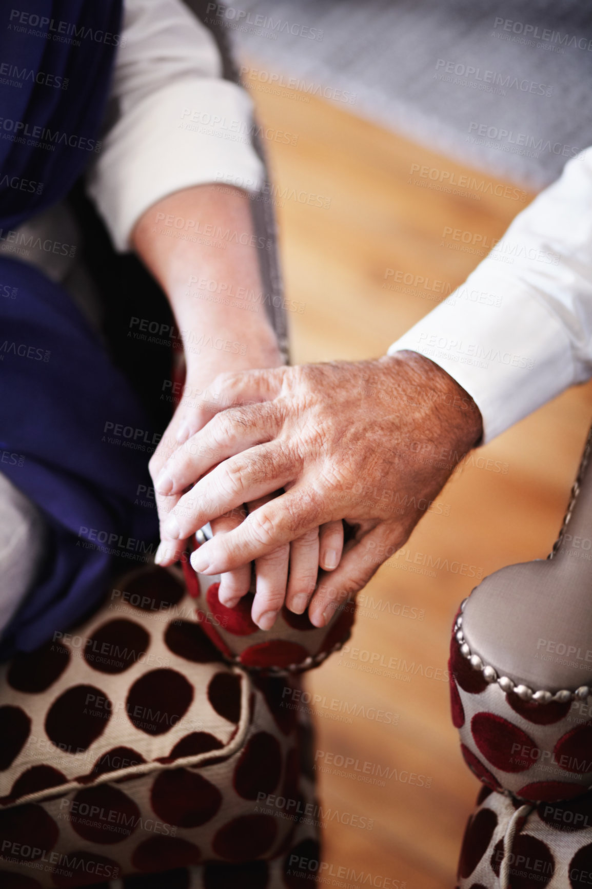 Buy stock photo Old couple in living room, holding hands with love and support on retirement holiday together. Romantic marriage, senior man and woman on vacation in hotel lounge to relax, care and touch on armchair