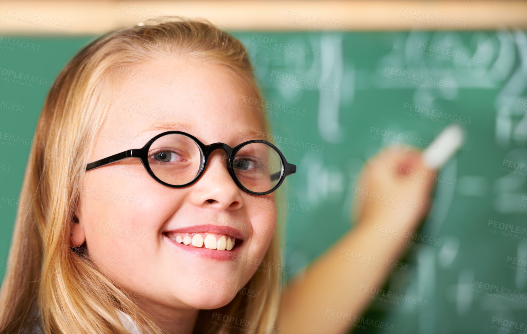 Buy stock photo Portrait, nerd and happy kid writing on chalkboard in class for learning, education and study math. Face, glasses and smile of geek at school, cute girl child and student in classroom in Australia