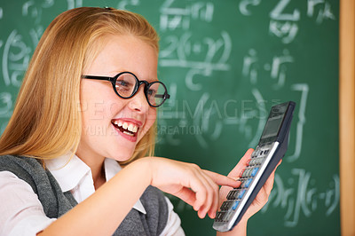 Buy stock photo Child, calculator and happy for education, learning and problem solving or solution on chalkboard. Smart student, kid or girl with glasses and excited for school, typing numbers and math in classroom
