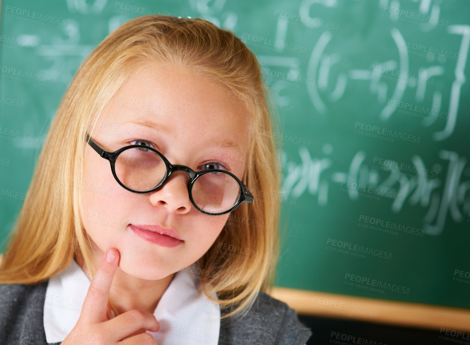 Buy stock photo Portrait of student, nerd and child thinking by chalkboard for learning knowledge, education or study math. Serious face, glasses and geek at school, ginger girl or kid in classroom in Switzerland