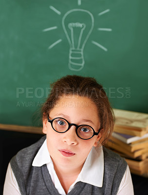 Buy stock photo Thinking, idea and portrait of student with light bulb on board for plan, decision or brainstorming in classroom. Education, learning and girl kid with drawing for choice, vision or future in school.