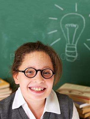 Buy stock photo Happy, smile and portrait of student with light bulb on board for plan, decision or brainstorming in classroom. Education, learning and girl child with drawing for choice, vision or future in school.