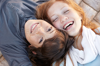 Buy stock photo Portrait, laughing and above of friends in nature for love, bonding and happiness. Smile, care and a boy, girl or sibling children on the ground together for a funny joke, friendship or playful