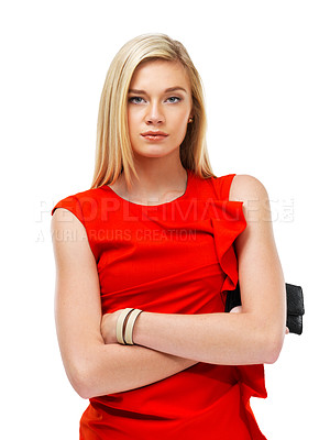 Buy stock photo A stunning young blonde woman standing with arms folded while holding a clutch bag