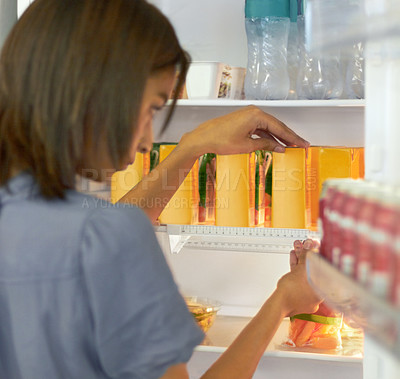 Buy stock photo Woman in kitchen arranging food in fridge with care, ruler and ocd behavior, symmetry and anxiety. Intrusive thinking, pattern and girl packing refrigerator with measurement, order and mental health.