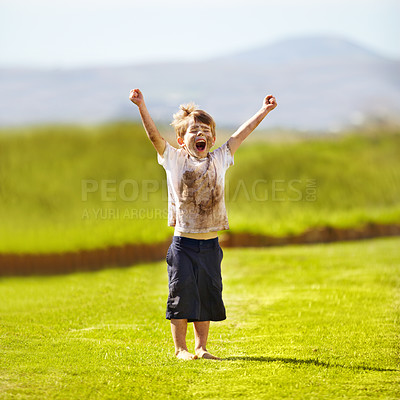 Buy stock photo Cute little boy cheering while standing outdoors