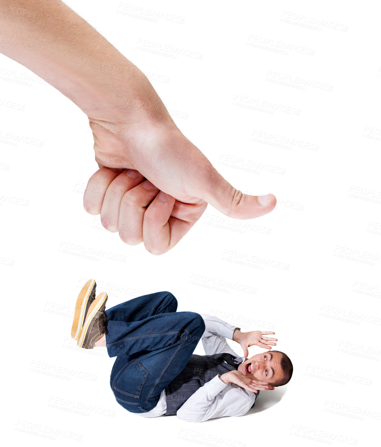 Buy stock photo A fearful young man lying on the ground with a giant thumb looking to squash him