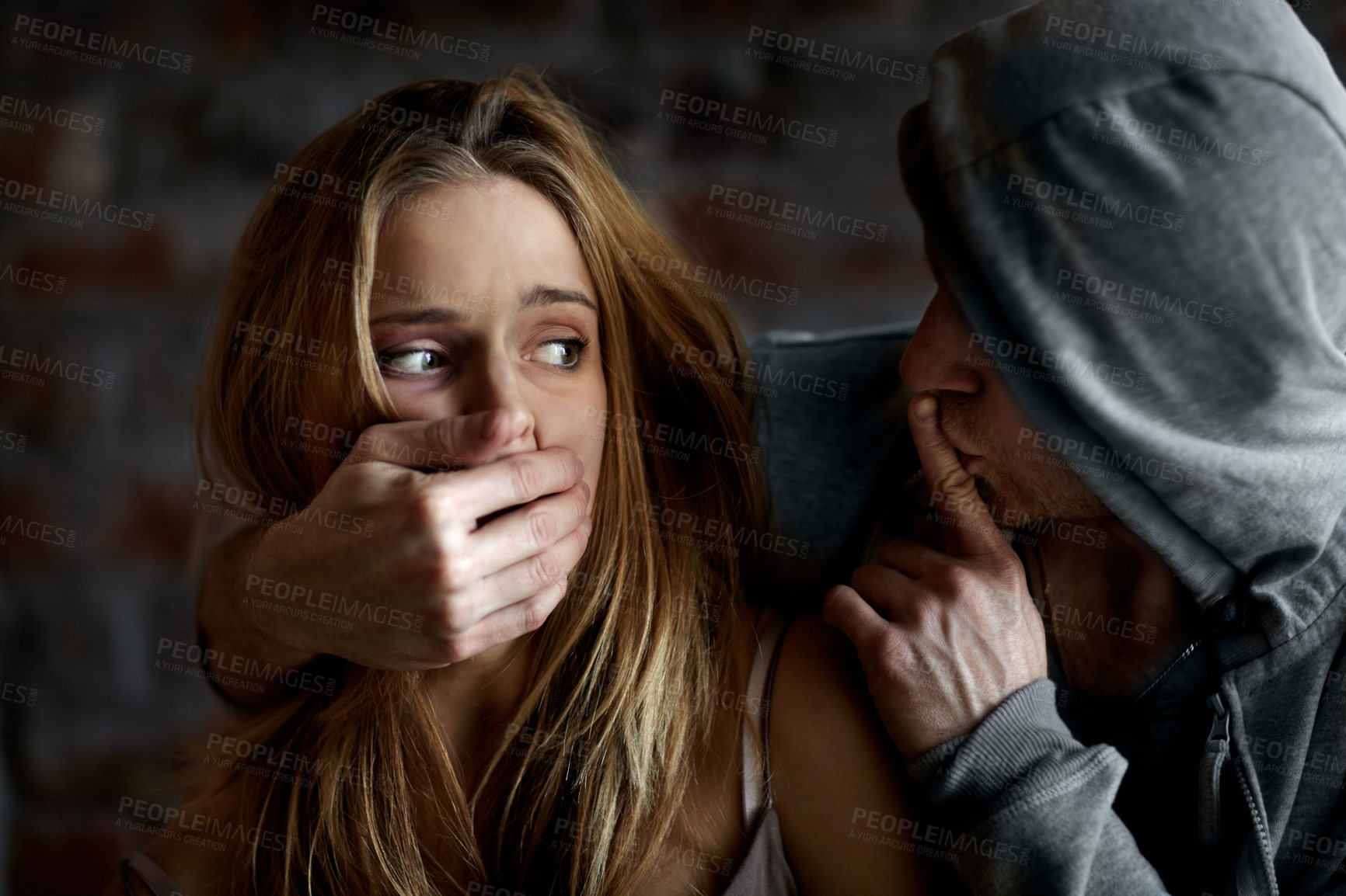Buy stock photo Abused young woman being silenced by her abuser
