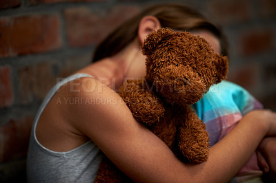 Buy stock photo Abuse, girl and child with fear, teddy bear and stress with depression, anxiety and bullying. Person, kid and victim with a toy, home and sad with mental health, crisis and trauma with development