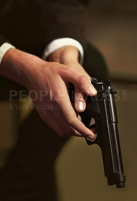 Buy stock photo Closeup, male hand and holding of gun for protection, power or security in mafia for criminal activity. Hitman, suit and sitting while wait for instruction, direction or order from boss with weapon