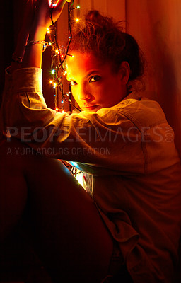 Buy stock photo Christmas lights, portrait and young woman in a room for festive decoration for the holidays. Celebration, modern and female person from Canada relaxing or chilling in a modern apartment or home.