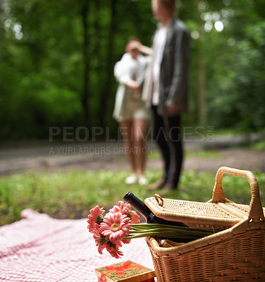 Buy stock photo Surprise, picnic and couple with love, nature and happiness with marriage, anniversary and romance. Romantic, man and woman with a basket, flowers and wine with relationship, countryside and excited
