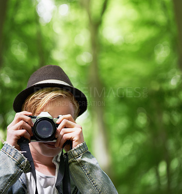 Buy stock photo Closeup portrait of a young man taking pictures with a vintage camera in the forest