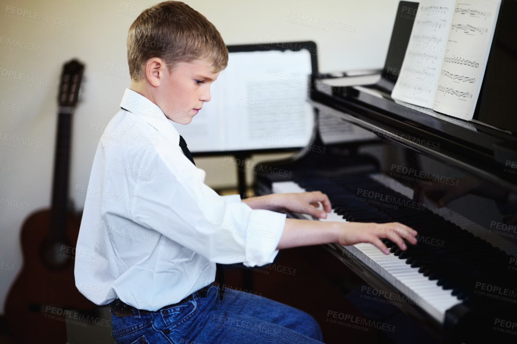 Buy stock photo Art, learning and child with piano in class with creative noise, playing audio and young musician with sound. Music, keys and pianist inspiration, boy in performance and talent show for children.