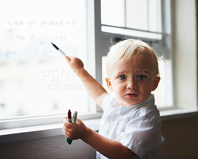 Buy stock photo Baby genius working out algebraic equations written on a clear window