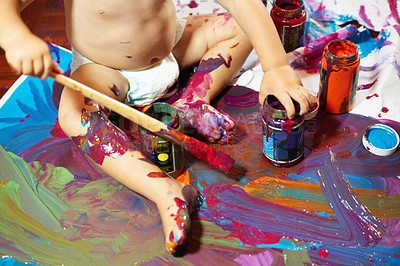 Buy stock photo Little baby boy painting on the floor with vibrant colors