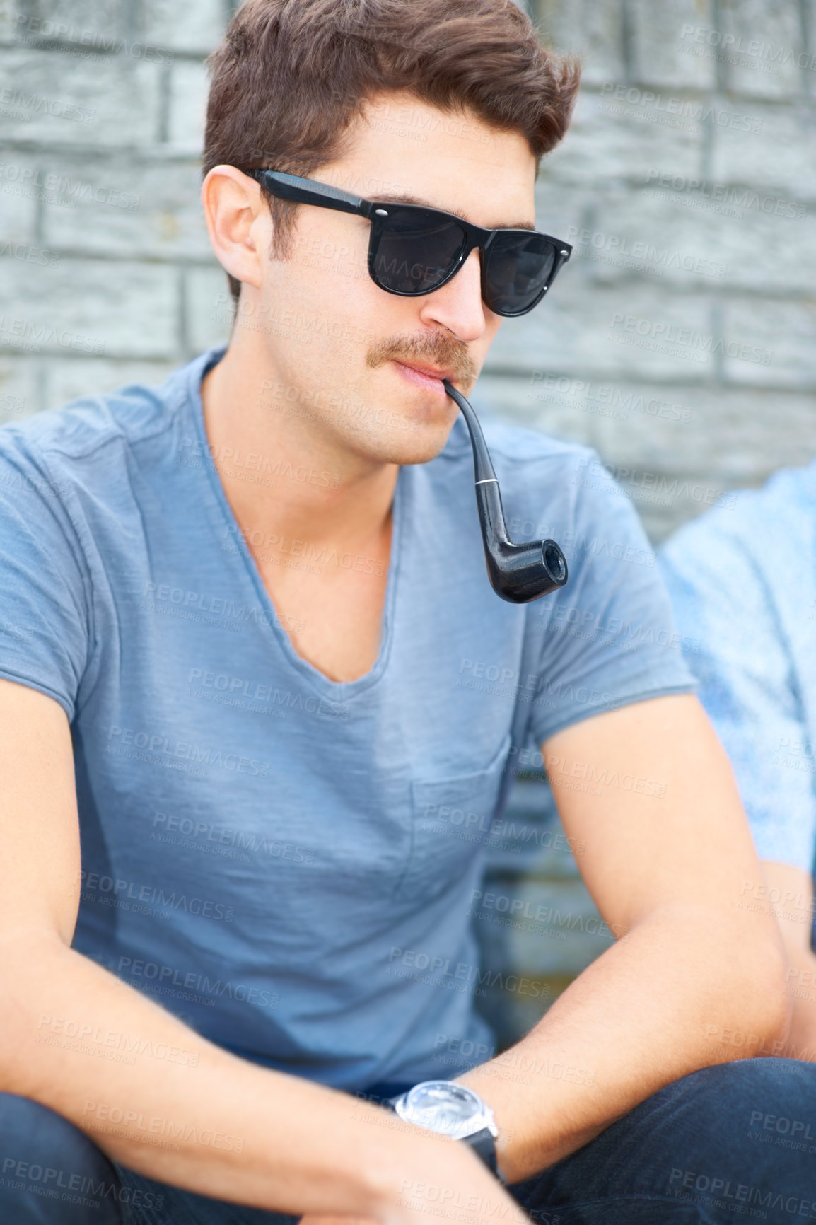 Buy stock photo Man in sunglasses, smoking pipe and thinking, relax outdoor and fashion in urban city by wall. Smoke, cool person in glasses or style, serious or hipster in casual clothes, tshirt and sitting in town