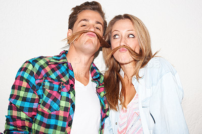 Buy stock photo Quirky, portrait and couple with hair moustaches being funny, comic and playful together in a studio. Crazy, young and a man and woman being silly and goofy on a date isolated on a white background