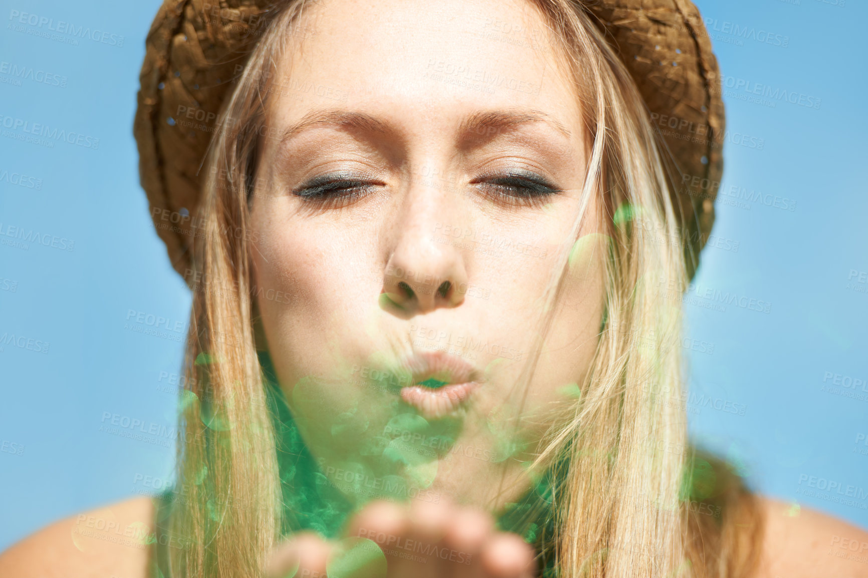 Buy stock photo Fun, blue sky and a woman blowing glitter for celebration, event or a party in the city. Face, closeup and a young girl with confetti or sparkle for a trend, wish or hope from a funky hipster