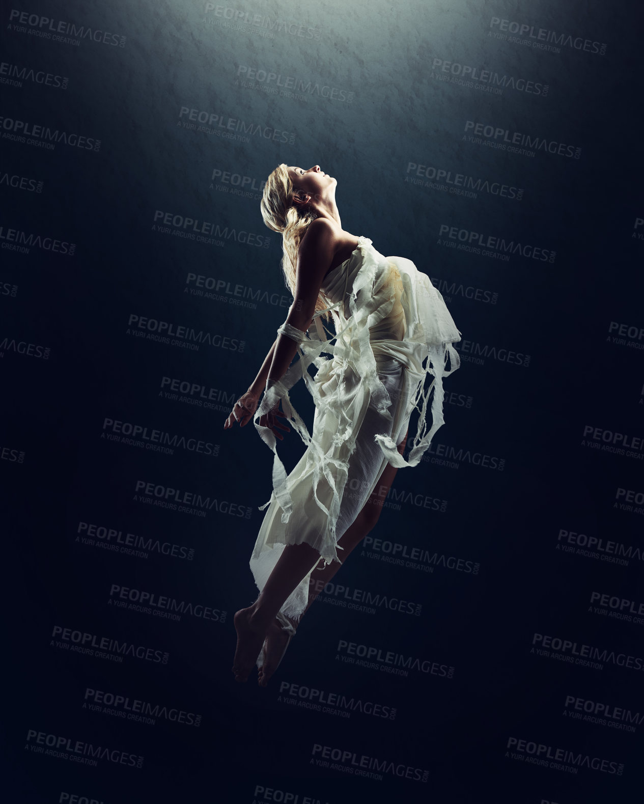 Buy stock photo A beautiful young woman floating in the air isolated against black