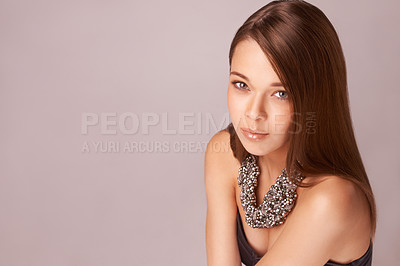 Buy stock photo Beautiful young woman wearing a beaded necklace against a pink background