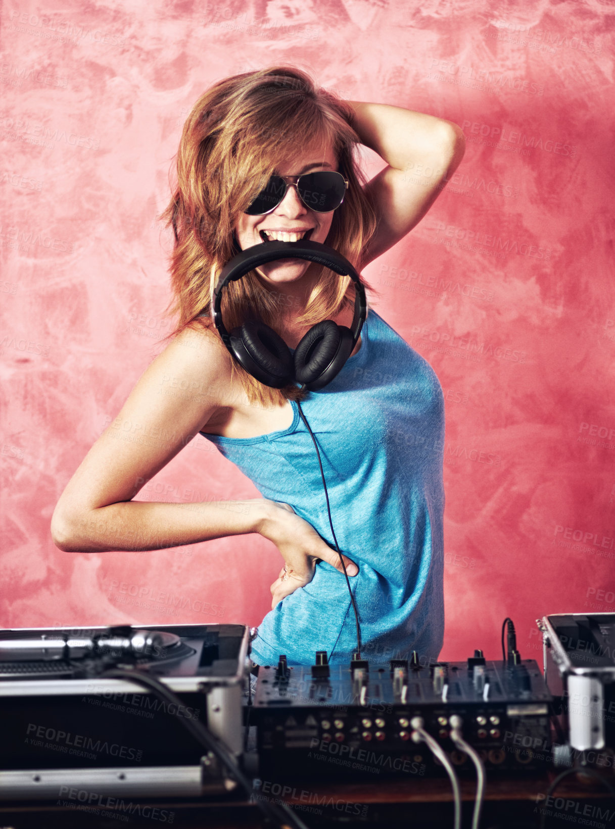 Buy stock photo Fun portrait of a dj with her earphones in her mouth