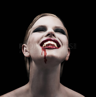 Buy stock photo A provocative female vampire feeling intense pleasure after feeding