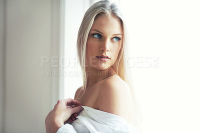 Buy stock photo An attractive young woman standing in her bedroom with her shirt hanging off her shoulders
