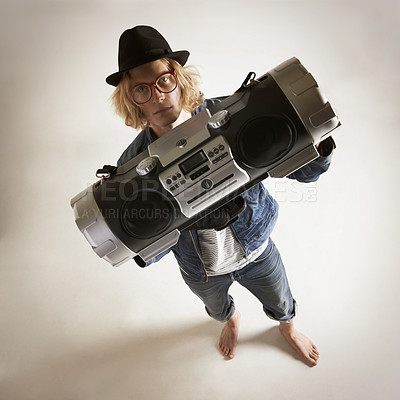 Buy stock photo Boombox, portrait and fashion of a man in studio with music, radio or audio sound and above. Serious model person on a grey background with denim outfit, glasses and hipster hat to listen to song