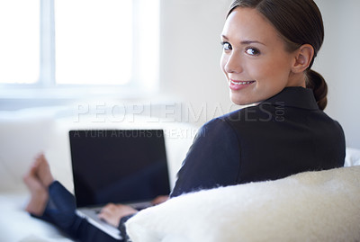 Buy stock photo Attractive young businesswoman working on her laptop at home