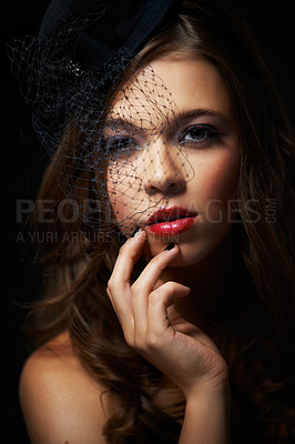 Buy stock photo A dramatically made-up young woman wearing a stylish hat with a netted veil