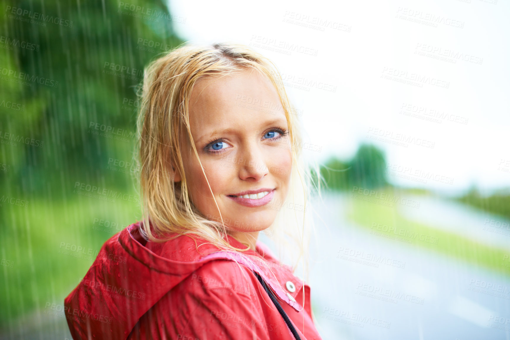 Buy stock photo Happy, portrait and young woman in the rain with coat in nature, road or street for winter. Smile, positive attitude and female person from Australia in drizzle or storm weather in outdoor forest.