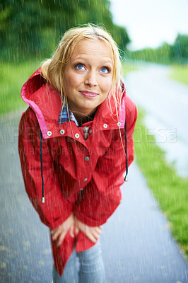 Buy stock photo Woman, rain and raincoat in nature, thinking and cold from weather, winter and outdoors. Female person, wet and red coat for fashion on trip, rainfall and protection from water, vacation and holiday