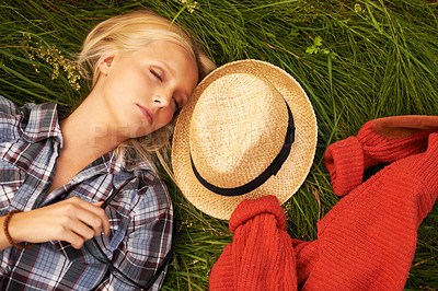 Buy stock photo Woman, sleep and rest on grass in nature to relax, peace and calm on field, outdoors and spring. Female person, eyes closed and nap on plants, dream and fashion on holiday, meadow and vacation